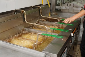 Deep fryers with boiling oil on fast food kitchen